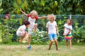 Happy kids play outdoor. Children skipping rope Royalty Free Stock Photo