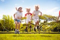 Happy kids play outdoor. Children skipping rope Royalty Free Stock Photo