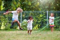 Happy kids play outdoor. Children skipping rope Royalty Free Stock Photo