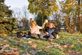 Happy kids playing with dog in sunny autumn park Royalty Free Stock Photo