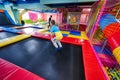 Happy kids playing at indoor play center playground. Boy jumping on trampoline Royalty Free Stock Photo