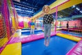 Happy kids playing at indoor play center playground. Girl ljumping on trampoline Royalty Free Stock Photo