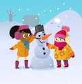 Happy kids playing with snowman. Funny little girs on a walk in the winter outdoors. Children building snow man playing