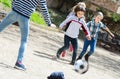 Happy kids playing street football outdoors Royalty Free Stock Photo