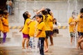 Happy kids playing in the water fountain
