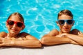 Happy kids in the pool, Funny kids in sunglasses playing outdoors, little boy and girl swim in the pool on a summer sunny day Royalty Free Stock Photo