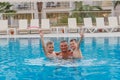 Happy kids in the pool with his father on vacation Royalty Free Stock Photo