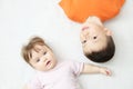 Happy kids, portrait of boy and baby girl, happiness in childhood of siblings, two children lying Royalty Free Stock Photo