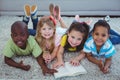 Happy kids reading a book together