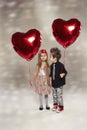 Happy kids with red heart balloon Royalty Free Stock Photo