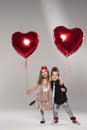 Happy kids with red heart balloon Royalty Free Stock Photo