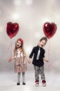 Happy kids with red heart balloon Royalty Free Stock Photo