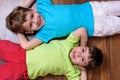 Happy kids relaxing laying on floor- top view