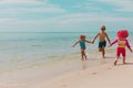 Happy kids run on beach, boy and girl play with water Royalty Free Stock Photo