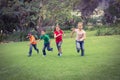 Happy kids running across the grass Royalty Free Stock Photo