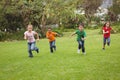 Happy kids running across the grass Royalty Free Stock Photo