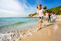 Happy kids running one after another on the beach Royalty Free Stock Photo