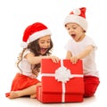 Happy kids in Santa hat opening a gift box Royalty Free Stock Photo