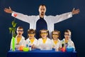 Happy kids with scientist doing science experiments in the laboratory