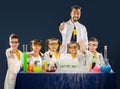 Happy kids with scientist doing science experiments in the laboratory Royalty Free Stock Photo