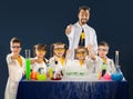 Happy kids with scientist doing science experiments in the laboratory