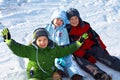 Happy kids sitting in snow