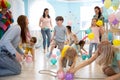 Happy kids and their parents entertain and have fun with color balloon on birthday party Royalty Free Stock Photo