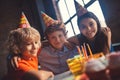 Three kids celebrating bday and smiling nicely