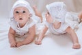 Happy kids twins in funny hats on a white background