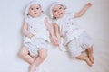 Happy kids twins in funny hats on a white background