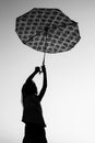 Happy Kids with an umbrella silhouette on nature in the park sunset