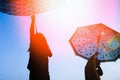 Happy Kids with an umbrella silhouette on nature in the park sunset