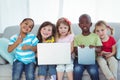 Happy kids using technology while sitting Royalty Free Stock Photo