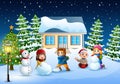 Happy kids wearing a winter clotes making a snowman in christmas day Royalty Free Stock Photo