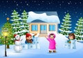 Happy kids wearing a winter clothes playing a snow in the christmas day Royalty Free Stock Photo