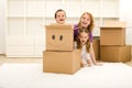 Happy kids and woman having fun in their new home Royalty Free Stock Photo