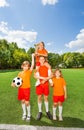 Happy kids with won cup stand in pyramid Royalty Free Stock Photo