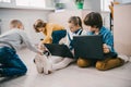 happy kids working with laptops on floor stem