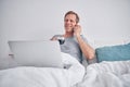 Relaxed mature man enjoying coffee in bed