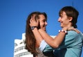 Happy kissing couple near new white building