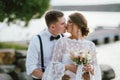 Happy kissing newly married couple, smiling bride brunette young woman with the boho style bouquet with groom, close up portrait Royalty Free Stock Photo