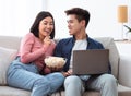 Happy Korean Couple Watching Movie On Laptop Online At Home Royalty Free Stock Photo