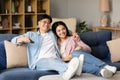 Happy Korean Couple Watching Movies On TV Relaxing At Home Royalty Free Stock Photo