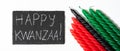 Happy Kwanzaa concept. Afro-American holiday. Congratulatory lettering and seven candles - red, black and green. African Royalty Free Stock Photo