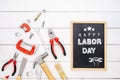 Happy Labor Day background concept. Flat lay of construction handy tools with black chalkboard with happy labor day text over