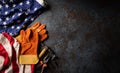 Happy Labor day concept. American flag with different construction tools on dark stone background, with copy space for text Royalty Free Stock Photo
