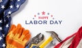 Happy Labor day concept. American flag with different construction tools on white background, with copy space for text