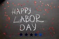 Happy labor day text with chalk on chalkboard close up. Festive bright stars in american style