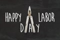 happy labor day text sign. pliers, tool for repairing and renovation concept on black background top view. working instruments Royalty Free Stock Photo