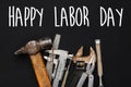 Happy labor day text sign. Working tools on black background. se Royalty Free Stock Photo